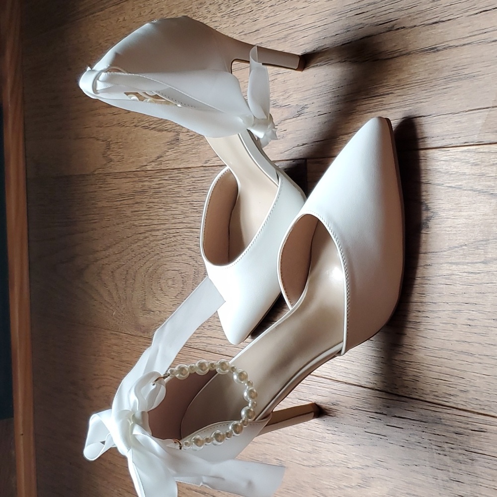 Off-white pumps with ribbon tie and pearl accent. New